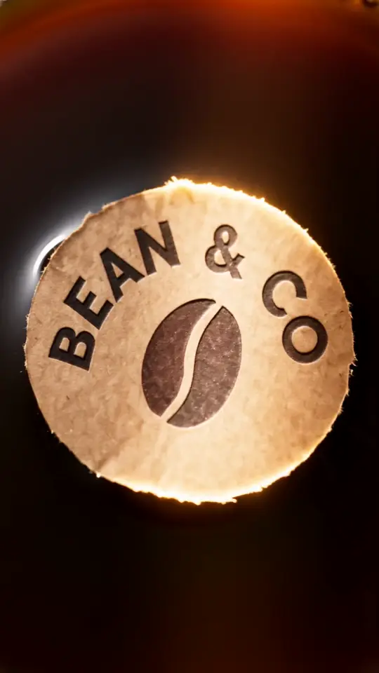 Café logo: beans, espresso swirl, logo on a cup