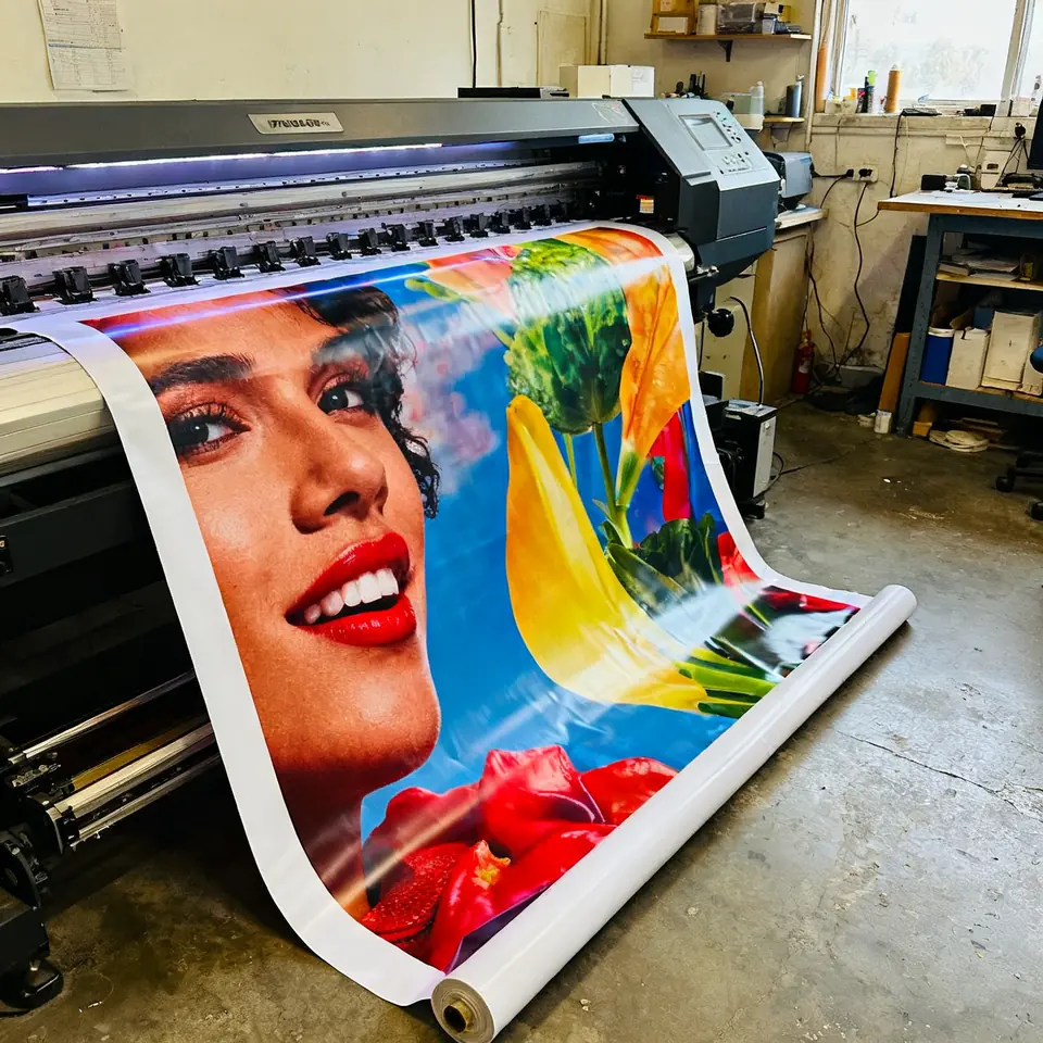Colourful vinyl banner coming out of a wide-format printer