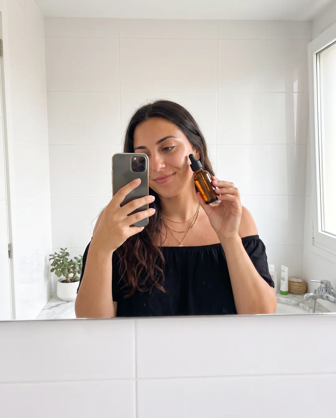 Bathroom mirror selfie with a serum bottle
