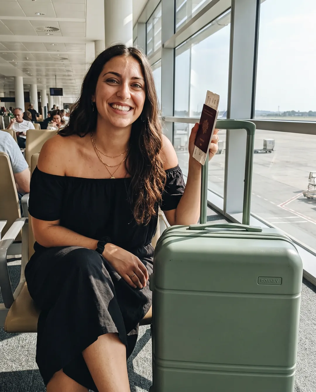 Airport lounge post with a carry-on (fictional brand “Roamly”)