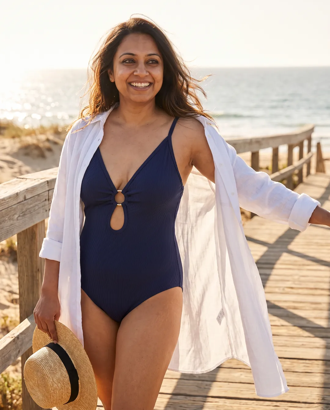 Styled with a linen shirt and straw hat on a boardwalk