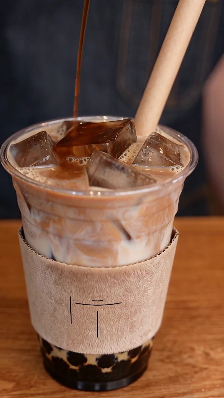 Actual frame from the completed milk-tea remake, showing the new cup, sleeve, straw and tapioca pearls